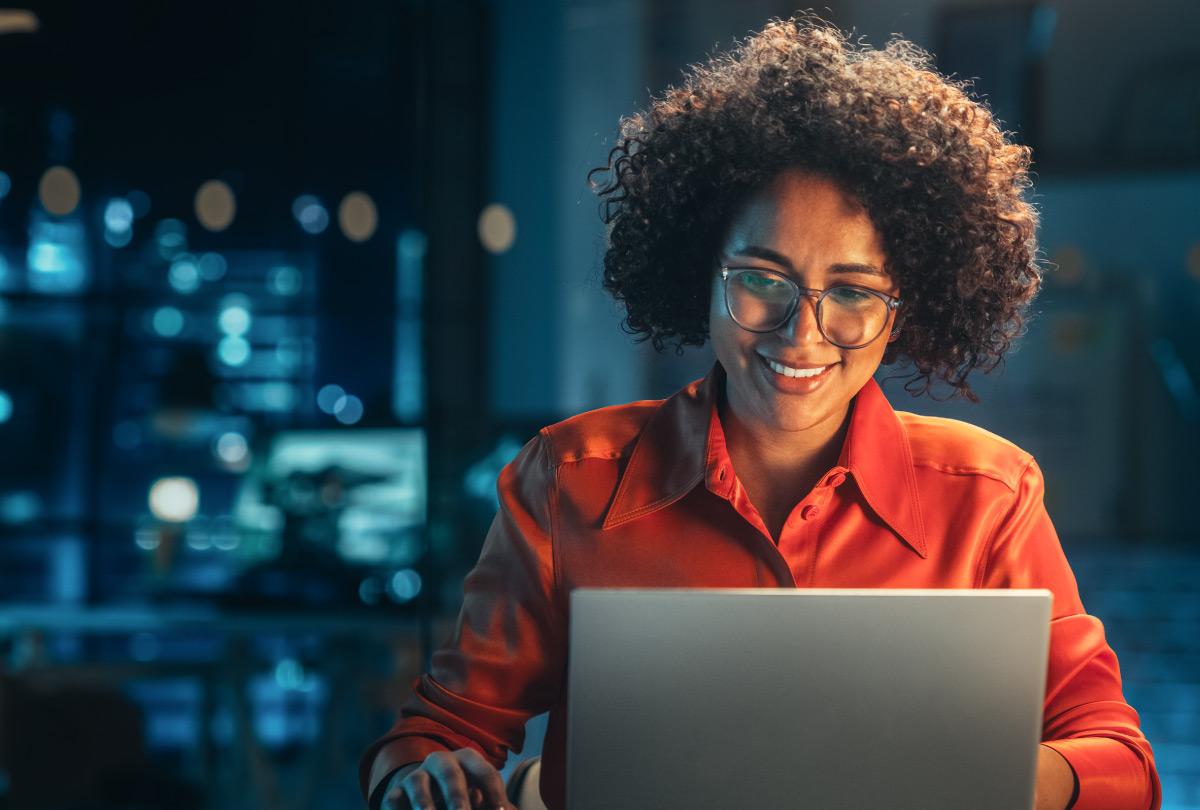 Smiling woman using a laptop computer