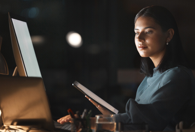 woman using multiple mobile devices